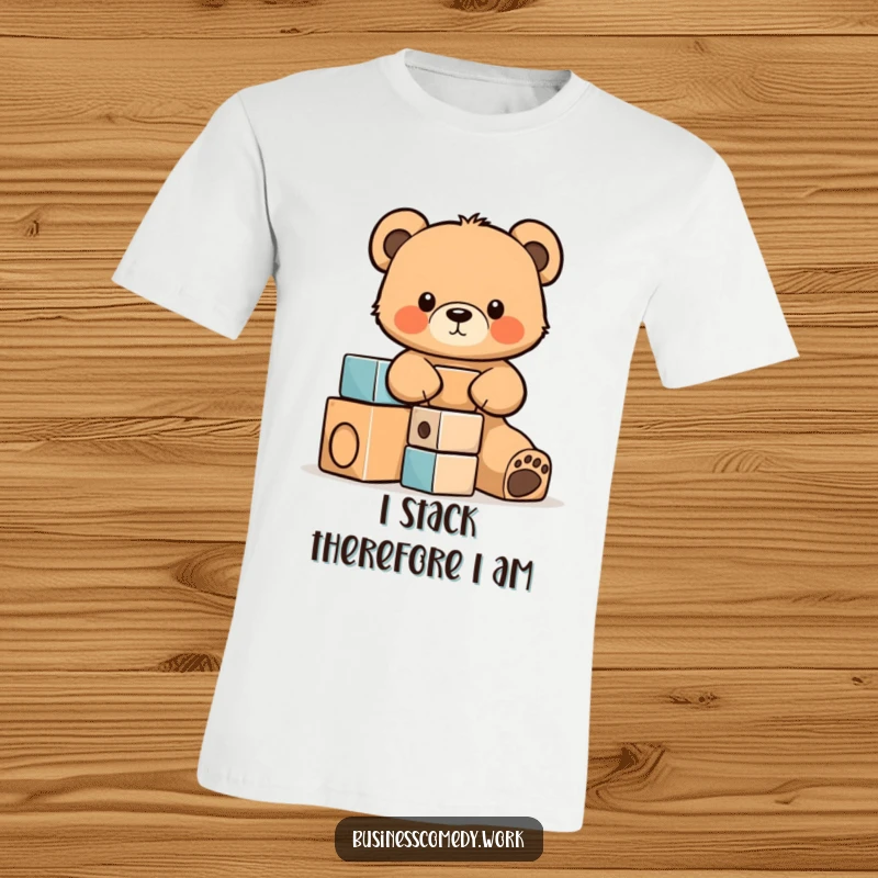 Funny t-shirt print of a cute bear cub cub intently stacking wooden building blocks, symbolizing focus and adorable effort.